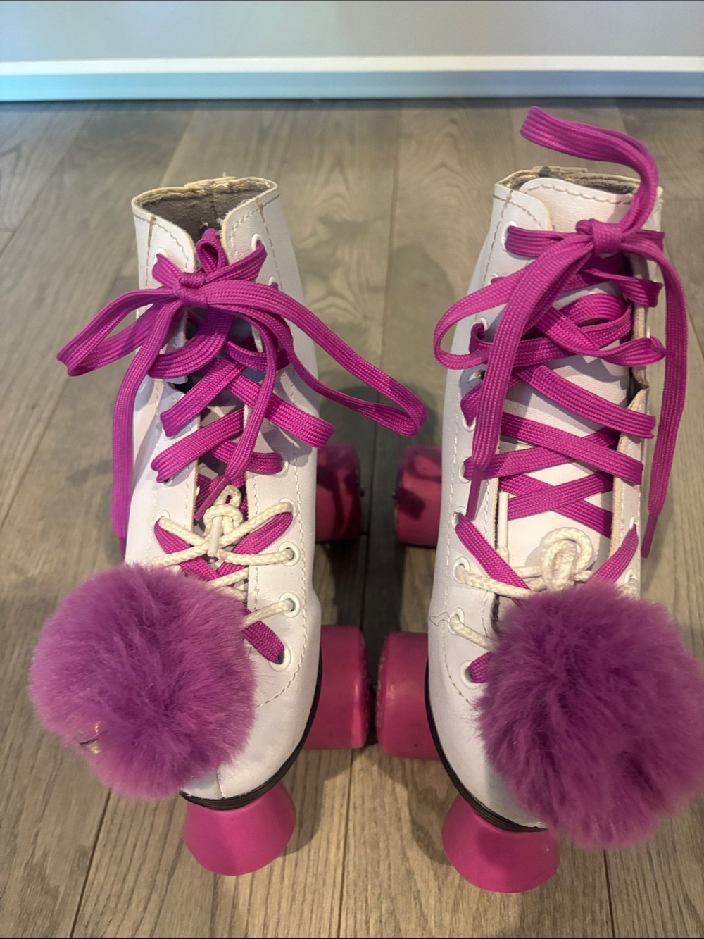 Girls White Roller Skates with Fuchsia  Wheels and Pom-Pom Accent